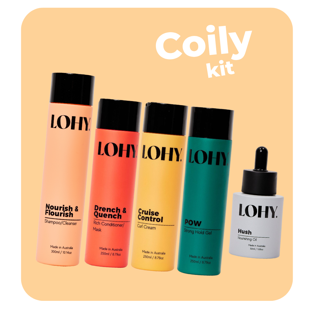lohy. coily hair kit, which includes shampoo, rich conditioner, curl cream, strong hold gel and nourishing oil bottles angled on a pastel yellow background