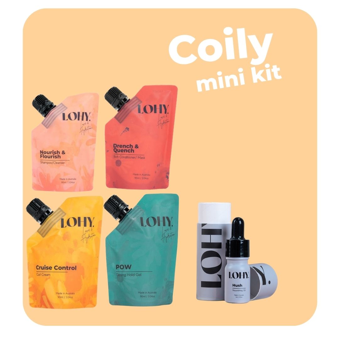 lohy. coily mini hair kit, which includes mini shampoo, mini rich conditioner, mini curl cream, and mini strong hold gel pouches, and nourishing oil bottles angled on a pastel yellow background