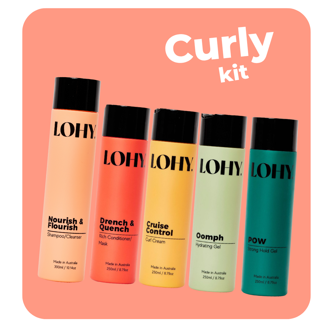 lohy. curly thick hair kit, which includes shampoo, rich conditioner, curl cream, strong hold gel and strong hold gel angled on a pastel red background