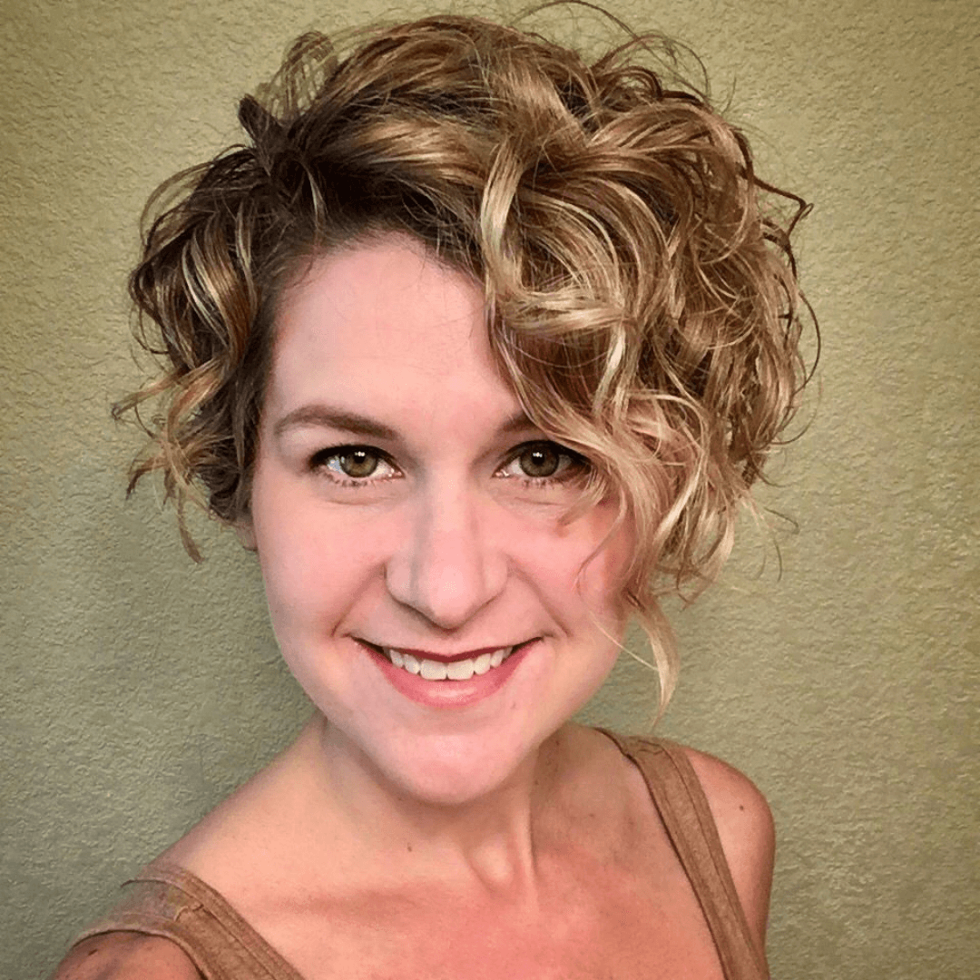 lady with short, curly, brunette hair