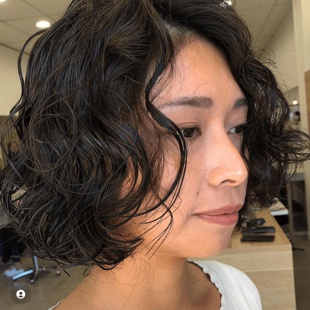 woman with short black curly hair