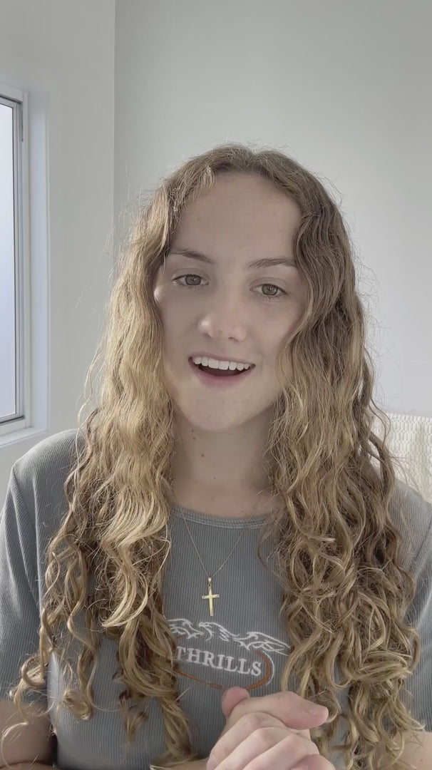 Load video: woman with brunette blonde wavy hair shows how to perform LOHY. hero routine which turns her frizzy hair to soft defined curls