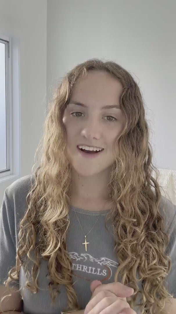 Load video: brunette red haired curly hair model, defines and shows how to do a hero routine on curly wavy hair with LOHY.