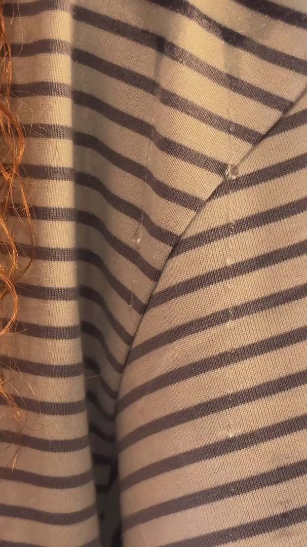 Load video: droplets falling down shirt then showing microfibre curly hair shoulder towel protecting clothes from water