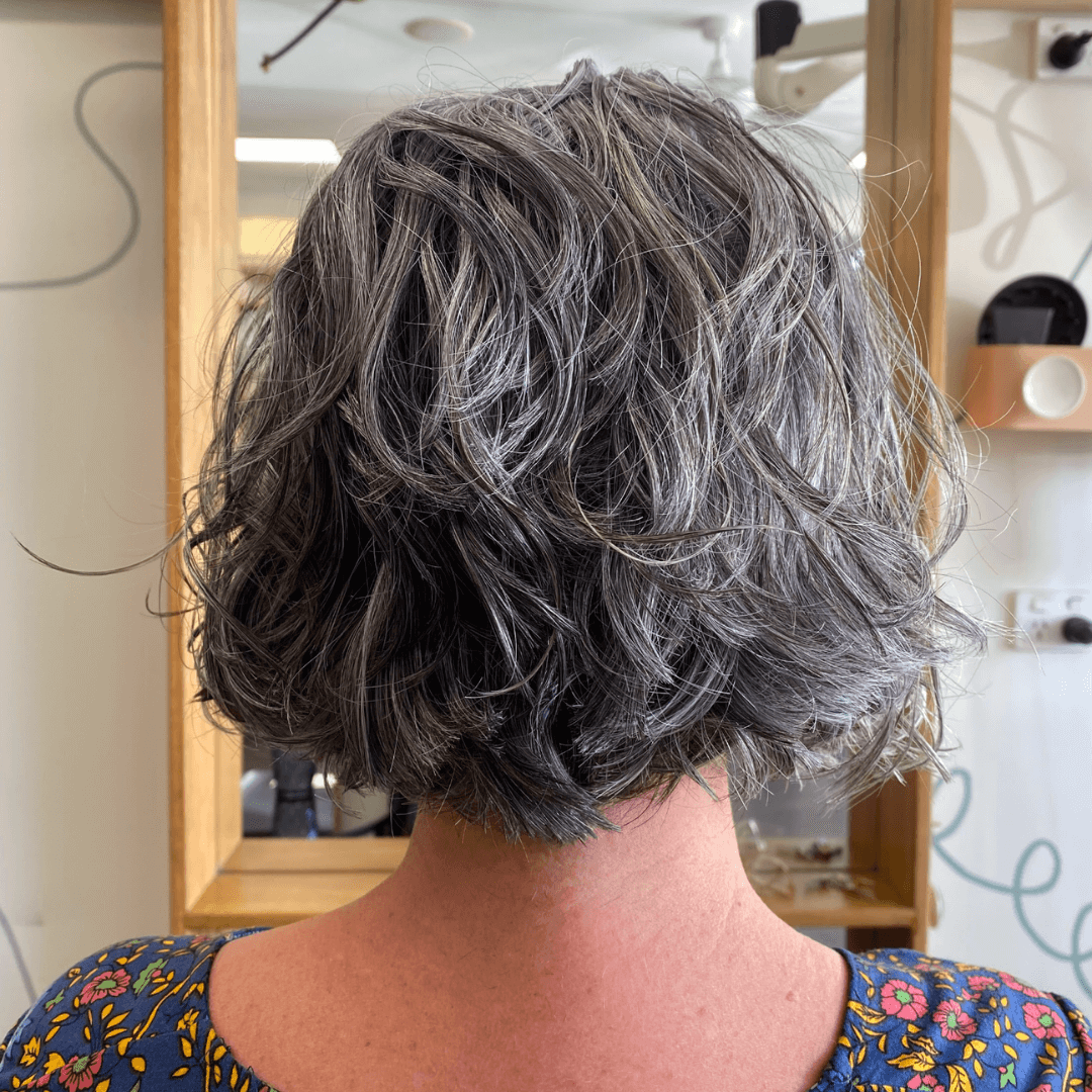 lady with short curly grey hair