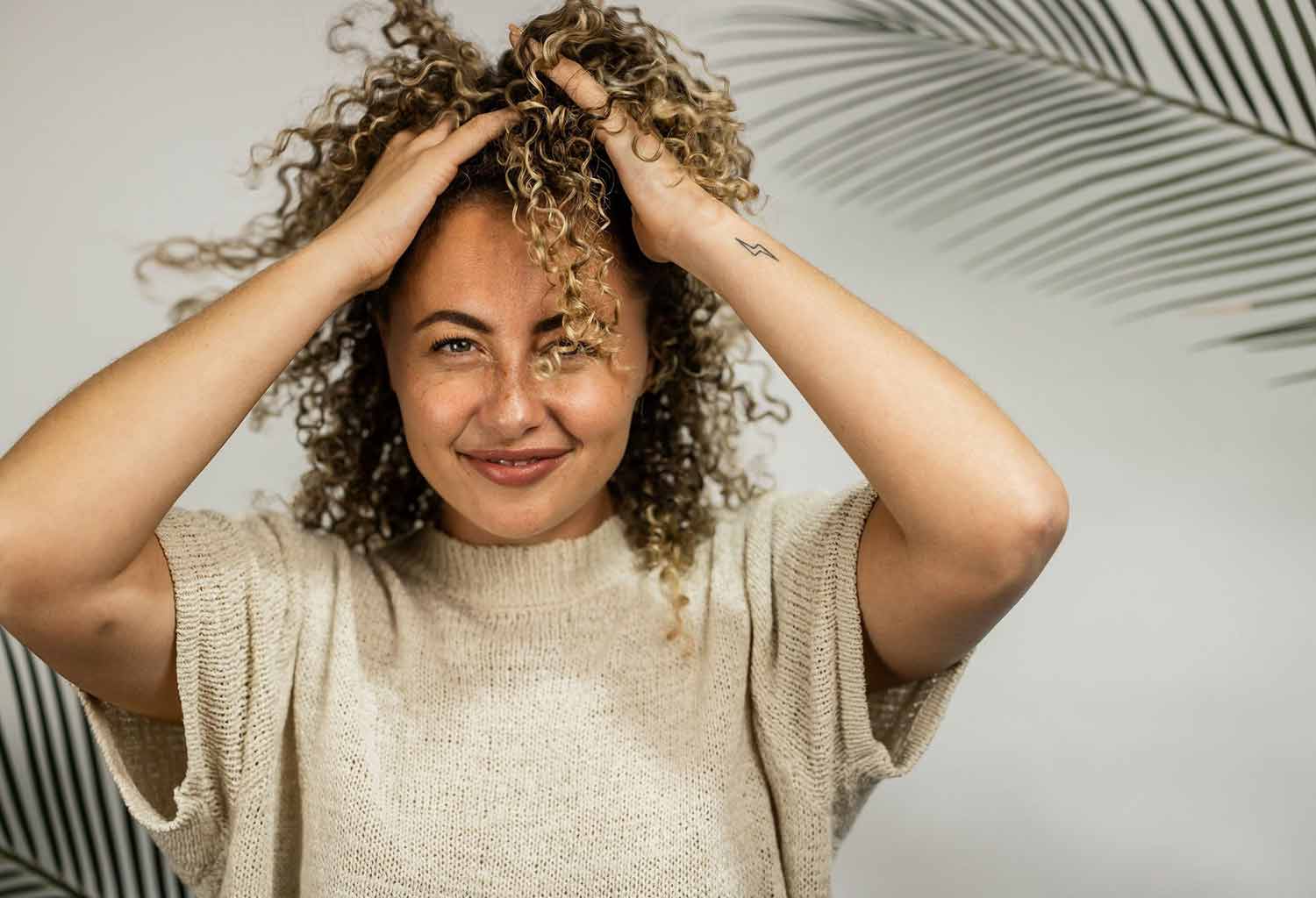 Girl running hands through blonde curls